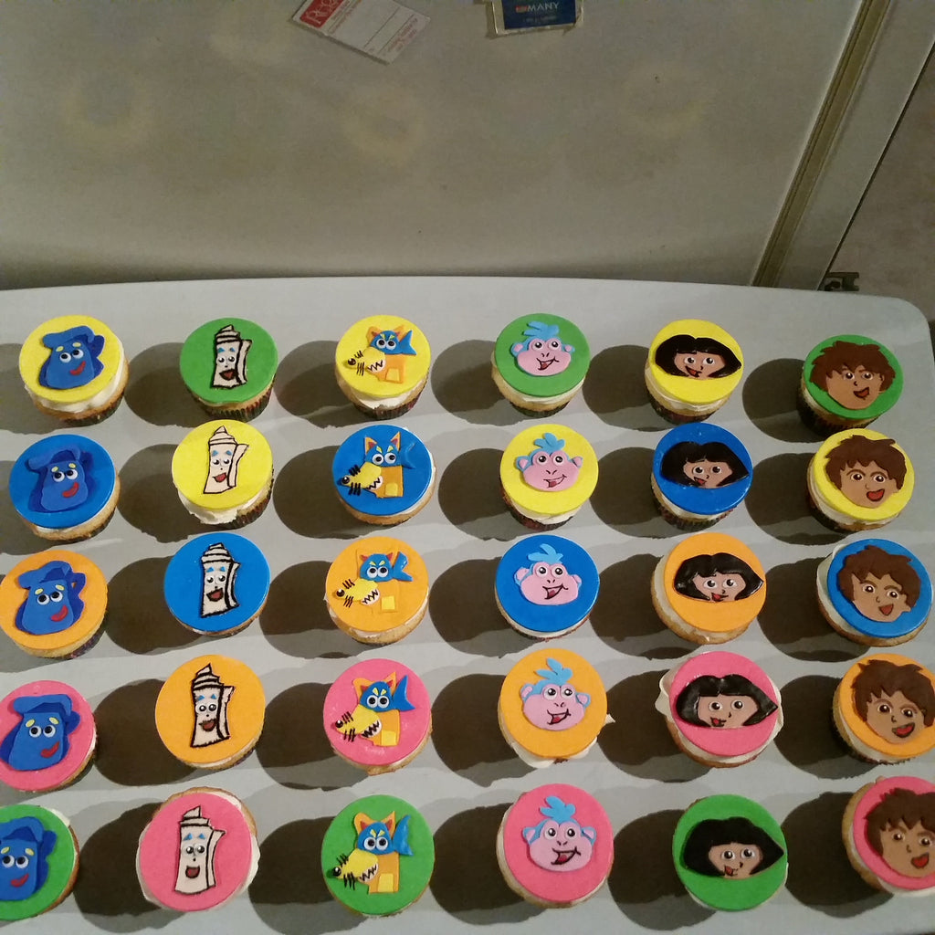 Dora Themed Vanilla Cupcakes with Flat Fondant Toppers $4.75/Cupcake. Minimum Order 1 Dozen