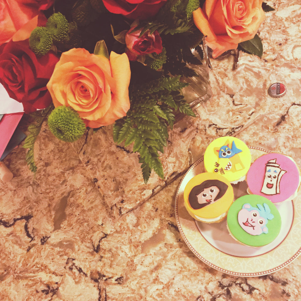 Dora Themed Vanilla Cupcakes with Flat Fondant Toppers $4.75/Cupcake. Minimum Order 1 Dozen